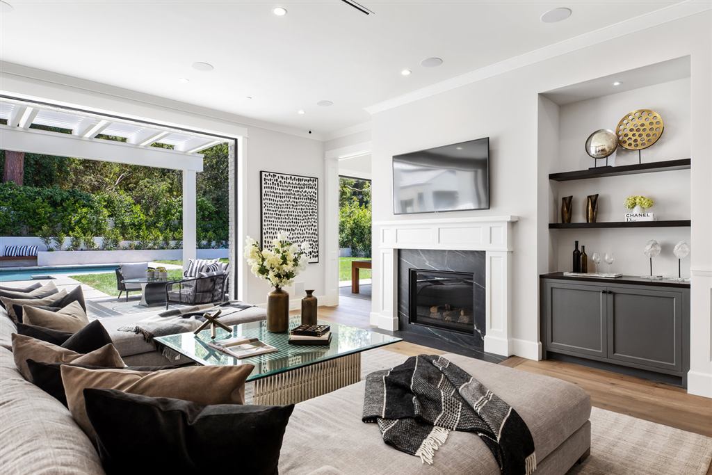 Living room with black steel window and door wall opening to the pool and patio, Bel-Air