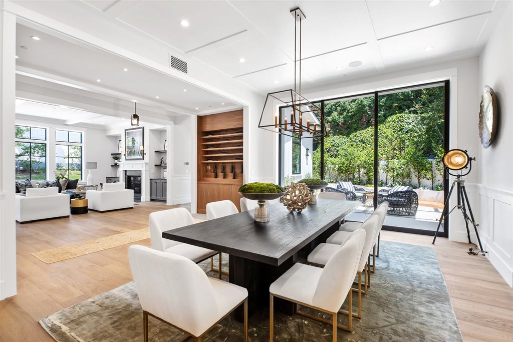 Dining room with black steel multi-slide door open to the backyard, Bel-Air