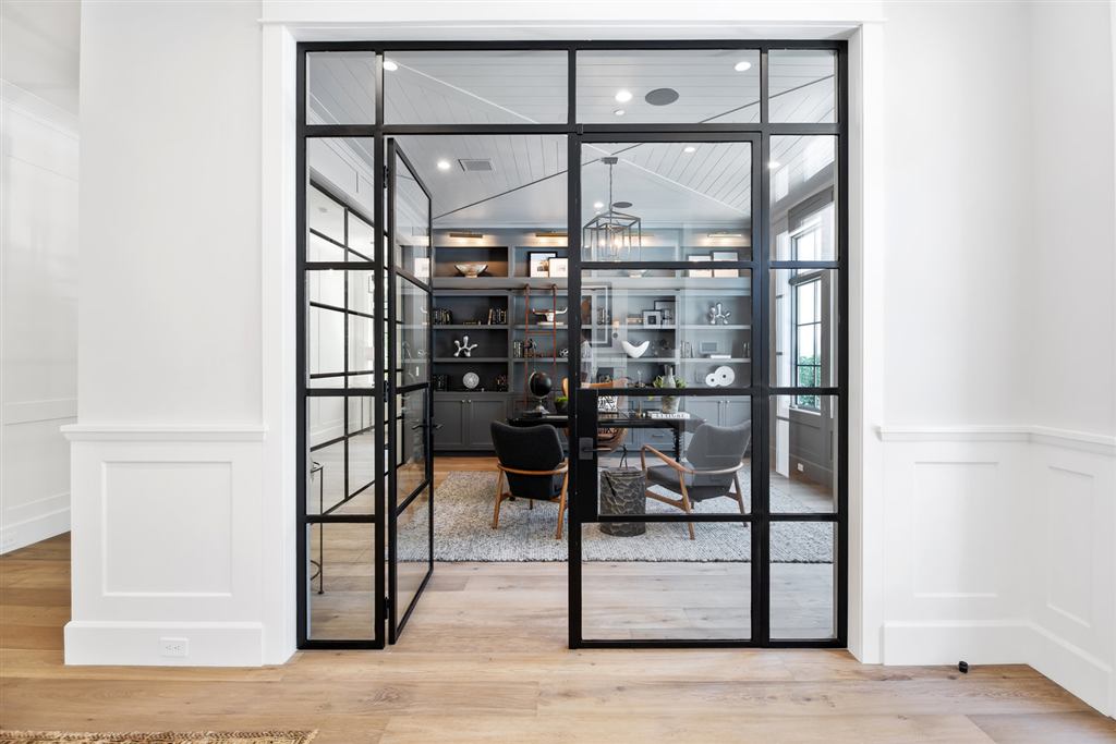 Steel-and-glass French doors opening into a built-in bookcase home office, Bel-Air