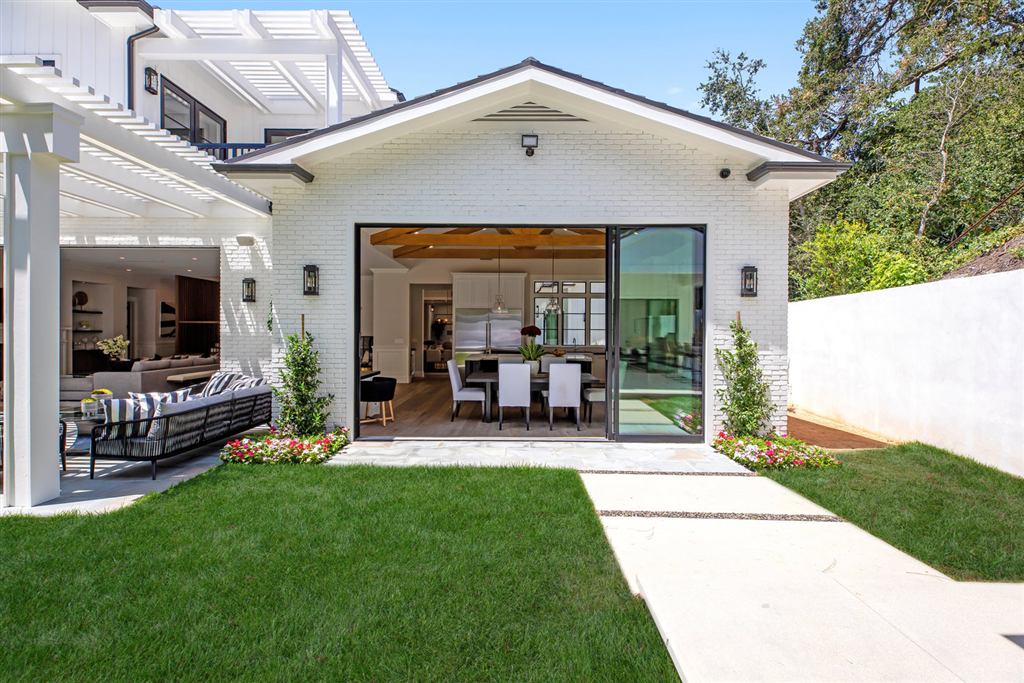 Detached pool house exterior with black multi-slide glass wall, Bel-Air new construction