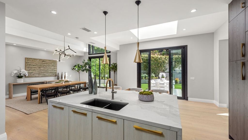Kitchen island with black aluminum-clad garden doors and a skylight beyond, Beverly Hills remodel