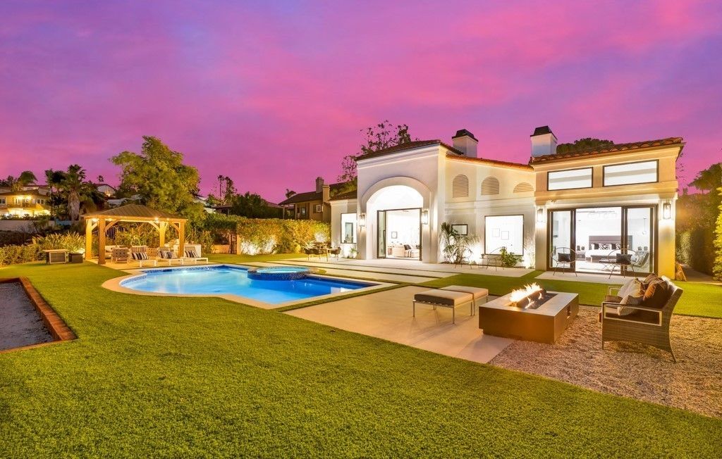 Calabasas remodel at sunset with multi-slide glass doors opening to the pool and patio