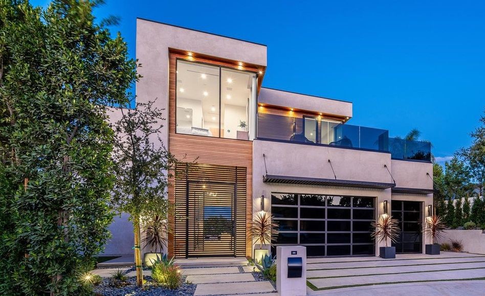 Daytime front elevation of an Encino new-construction home with a two-storey glass stair window in Arcadia aluminum