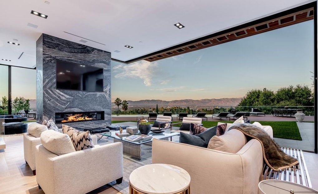 Living room in Encino with Arcadia aluminum sliding doors drawn fully open to the pool terrace and valley