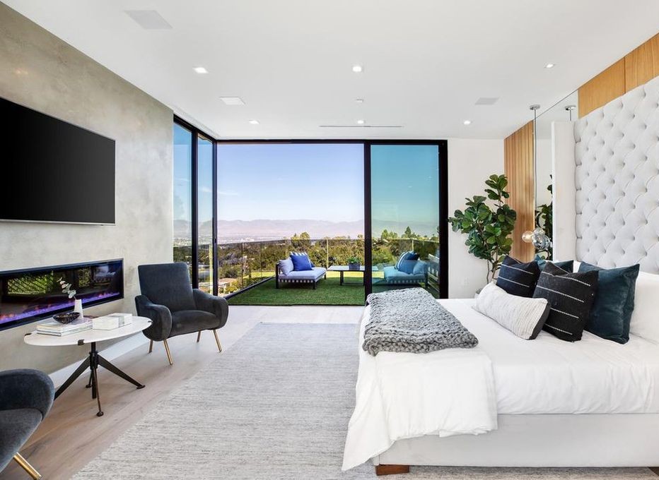 Primary bedroom in Encino with a corner of Arcadia aluminum sliding glass opening to the rear lawn
