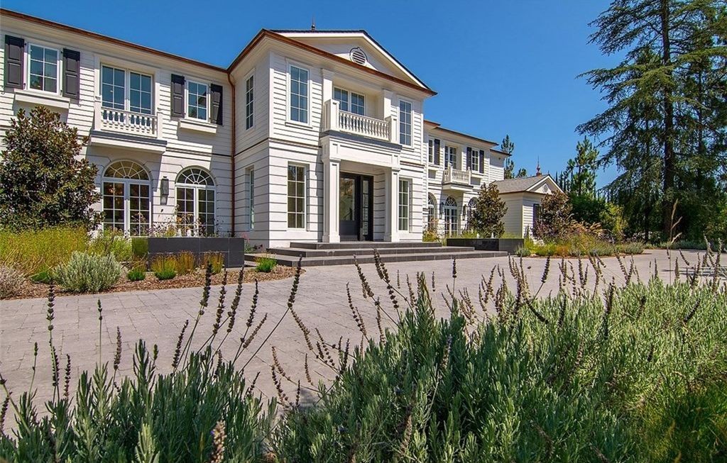 White colonial new construction in Hidden Hills with aluminum-clad windows, shutters, and French doors