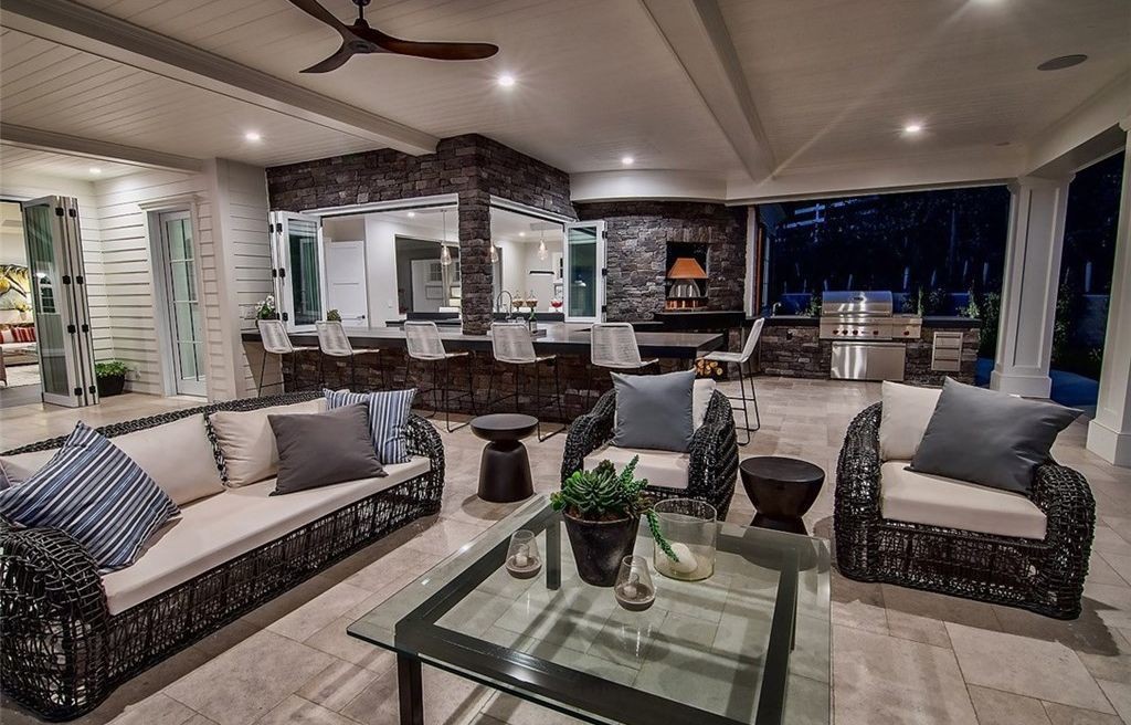 Covered outdoor living and kitchen with folding glass doors at night, Hidden Hills