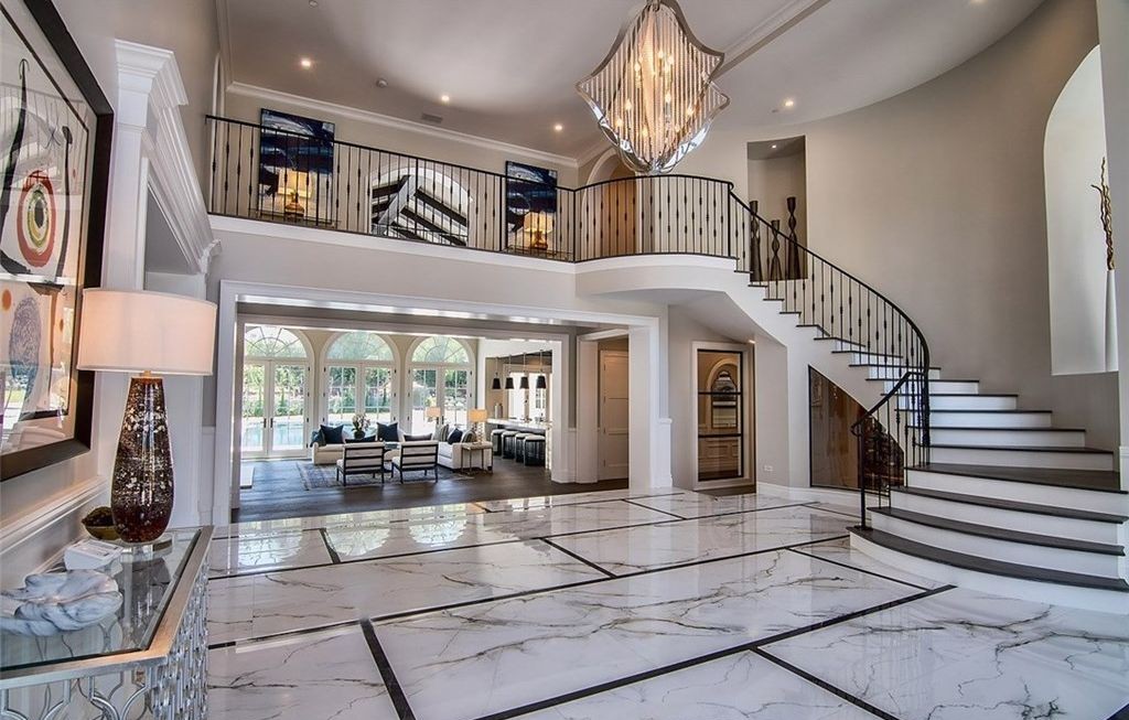 Two-story foyer with curved staircase and arched aluminum-clad windows, Hidden Hills new construction