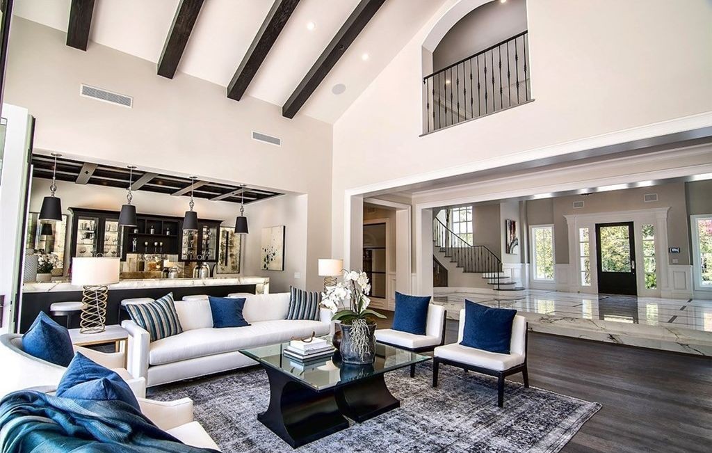 Living room with beamed vaulted ceiling opening to the marble foyer, Hidden Hills
