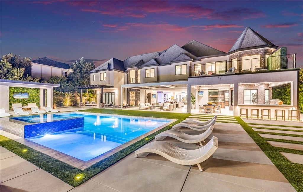 Woodland Hills backyard at sunset with large sliding glass doors opening to the pool deck