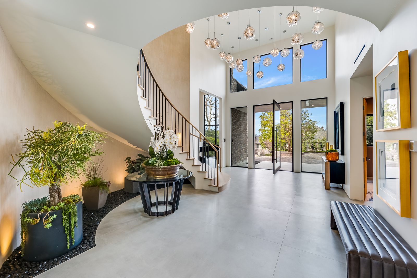 Two-story entry foyer with floor-to-ceiling glass and a pivot glass entry door, Woodland Hills