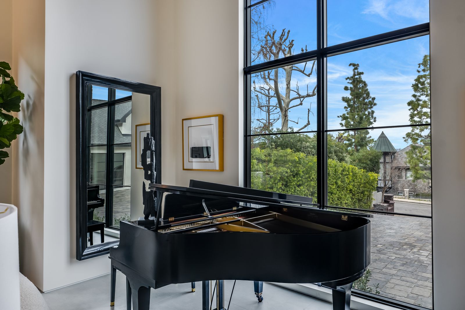 Grand piano beside a tall black-framed aluminum window with divided lites, Woodland Hills
