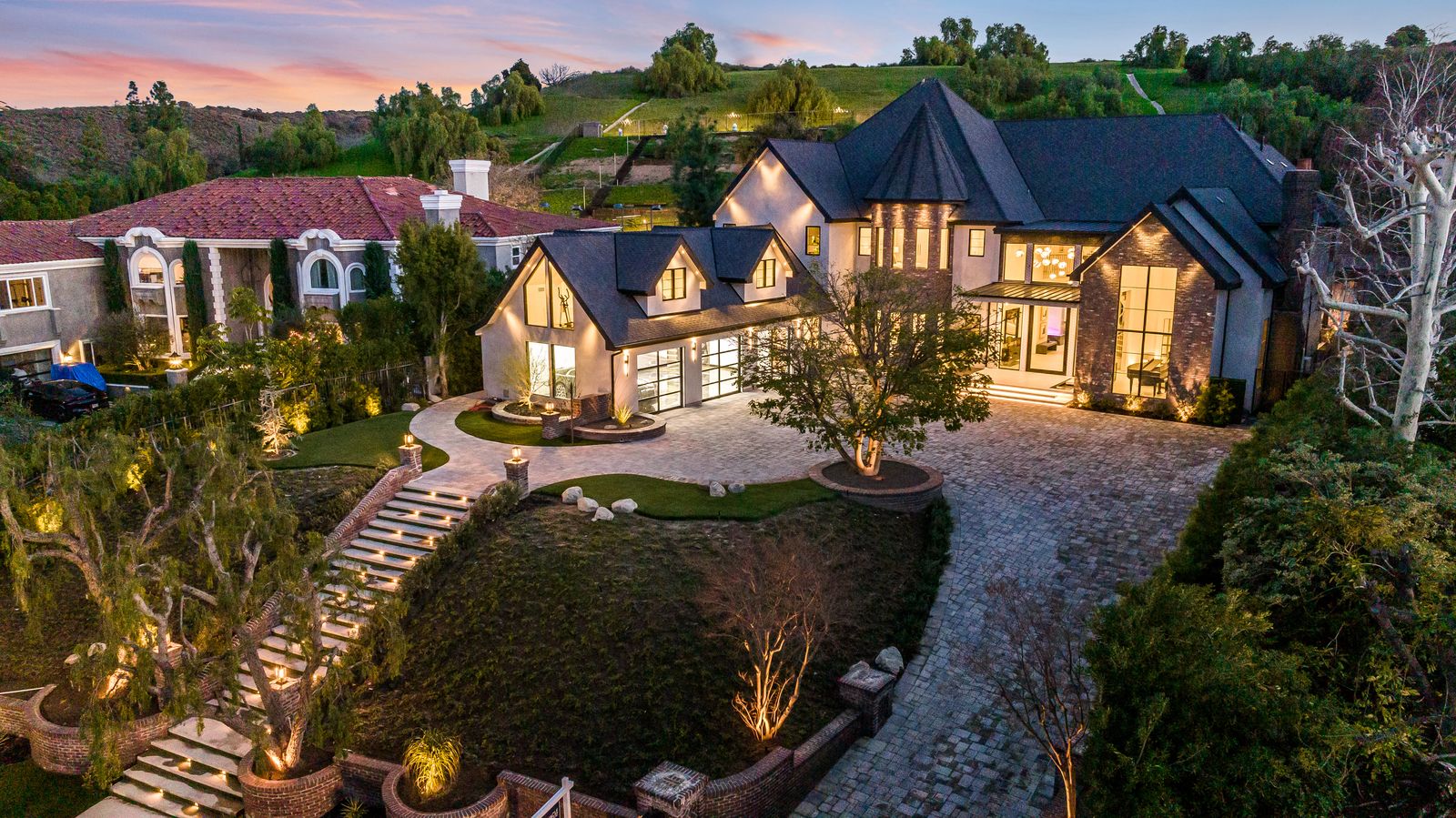 Aerial sunset view of a Woodland Hills estate remodel with extensive aluminum glazing