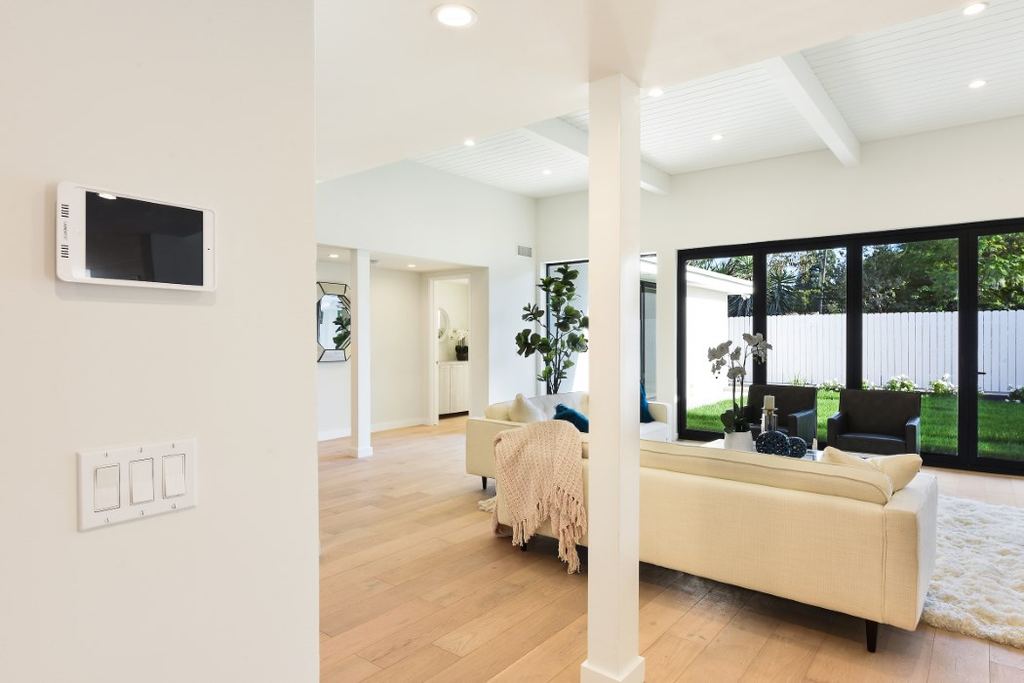 Entry hallway opening to the living room and black aluminum multi-slide doors to the backyard, Los Feliz remodel