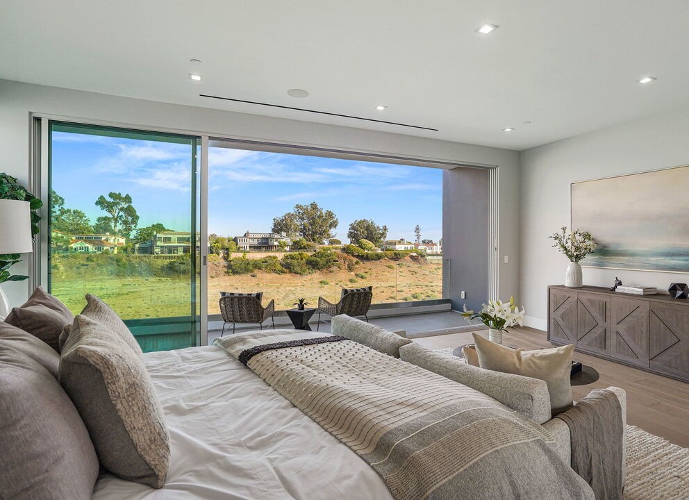 Bedroom in Pacific Palisades with a full-height Arcadia aluminum glass wall onto the garden and canyon view