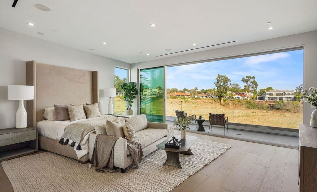 Primary bedroom in Pacific Palisades opening through Arcadia aluminum sliding doors to a terrace and open view