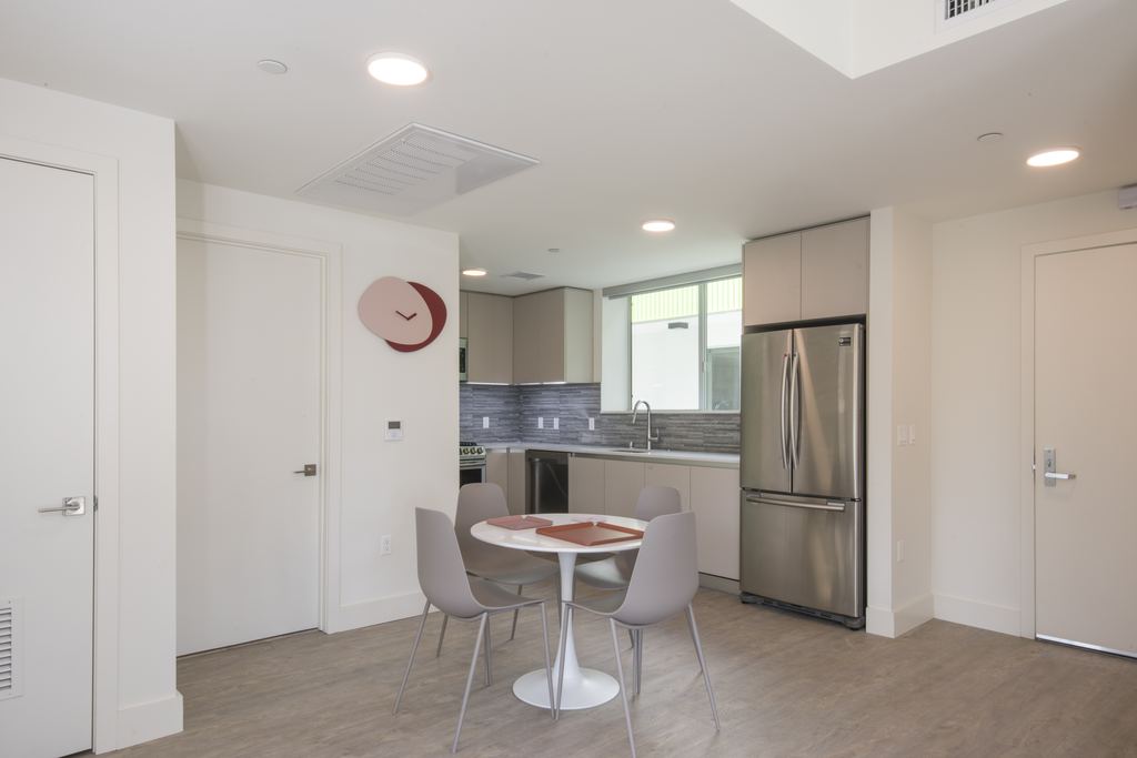 Kitchen and dining area with an aluminum window over the counter, Studio City multifamily project