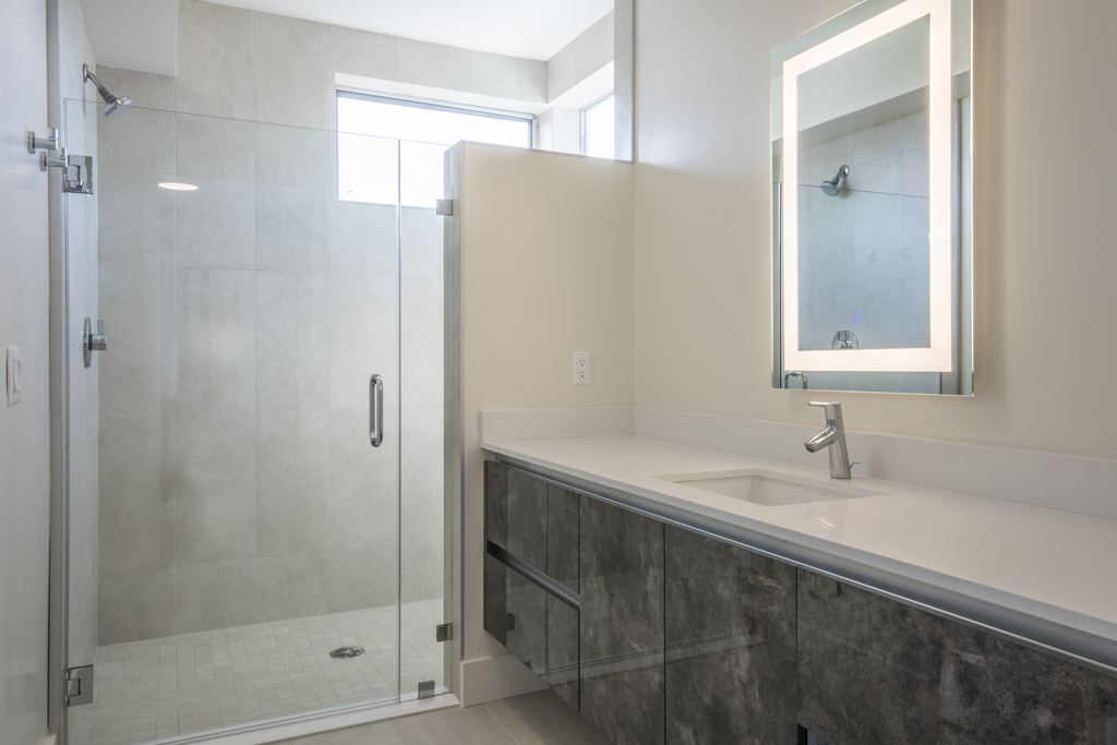 Bathroom with a horizontal aluminum clerestory window above the shower enclosure, Studio City multifamily project