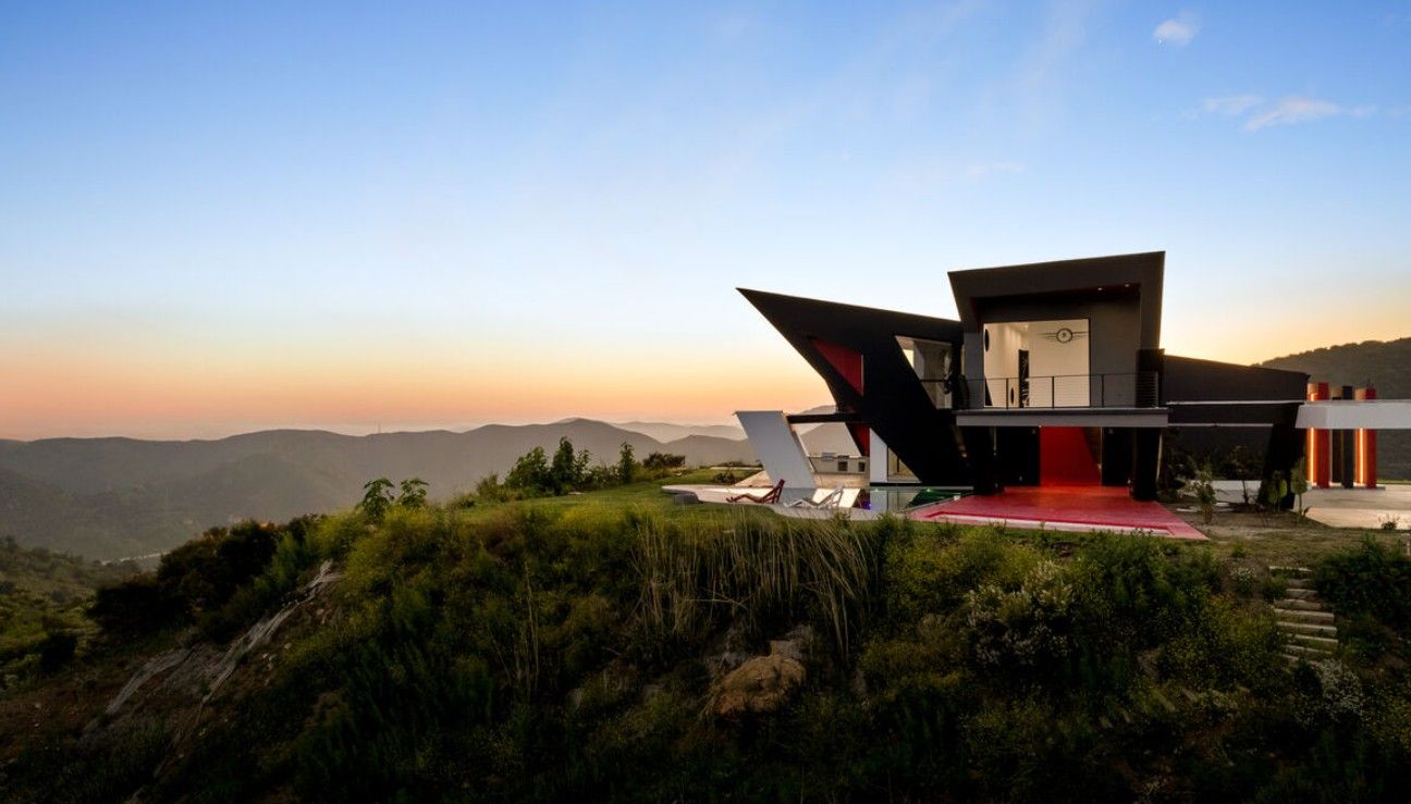 Angular Topanga Canyon residence at sunset, expansive glazing framing canyon and mountain views
