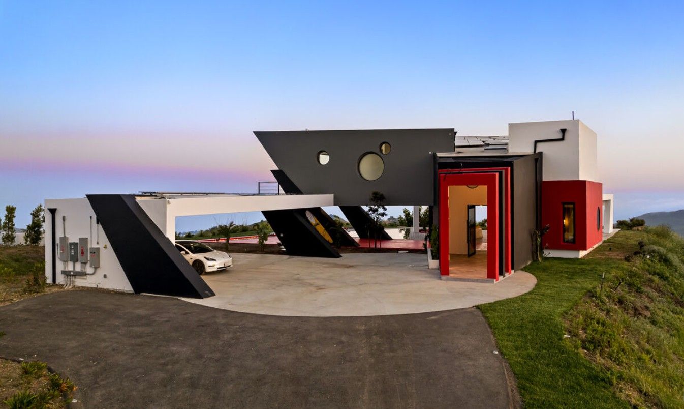 Entry approach with red accent doorway and steel windows on an angular modern home, Topanga Canyon